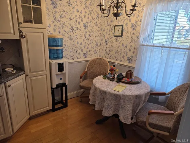 a kitchen with granite countertop a sink a stove and cabinets