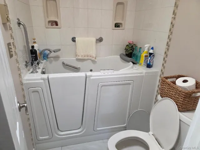 a bathroom with a bathtub and shower