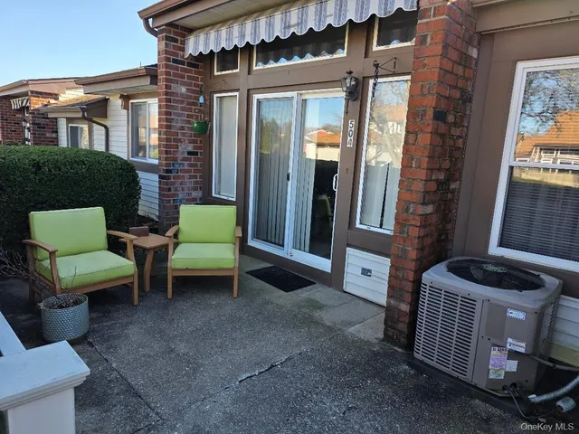 a couple of chairs in front of a house