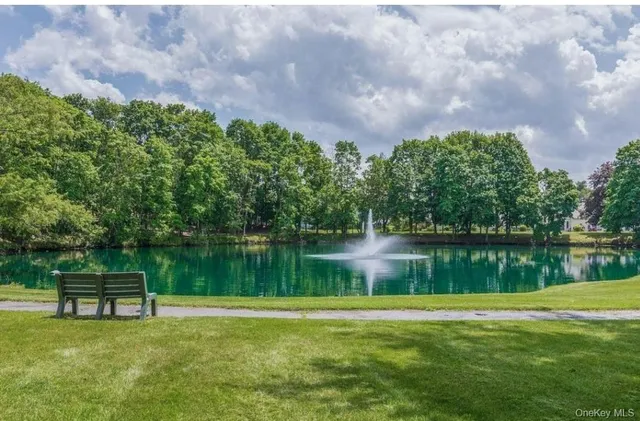 a kitchen with stainless steel appliances granite countertop a sink a refrigerator and a stove