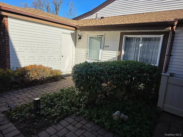 a room with pool table and windows