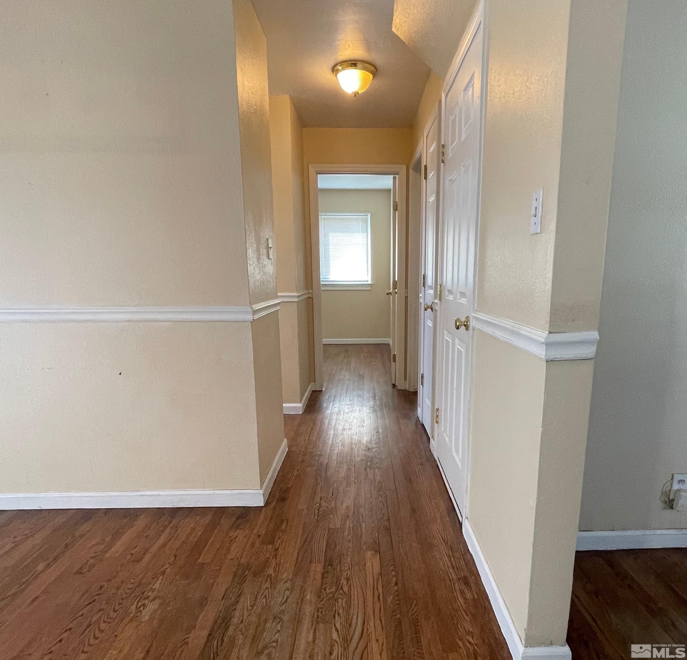 4500 Aster Drive Reno, NV 89502 - Photo 5 of 10 a view of a hallway with wooden floor and stairs