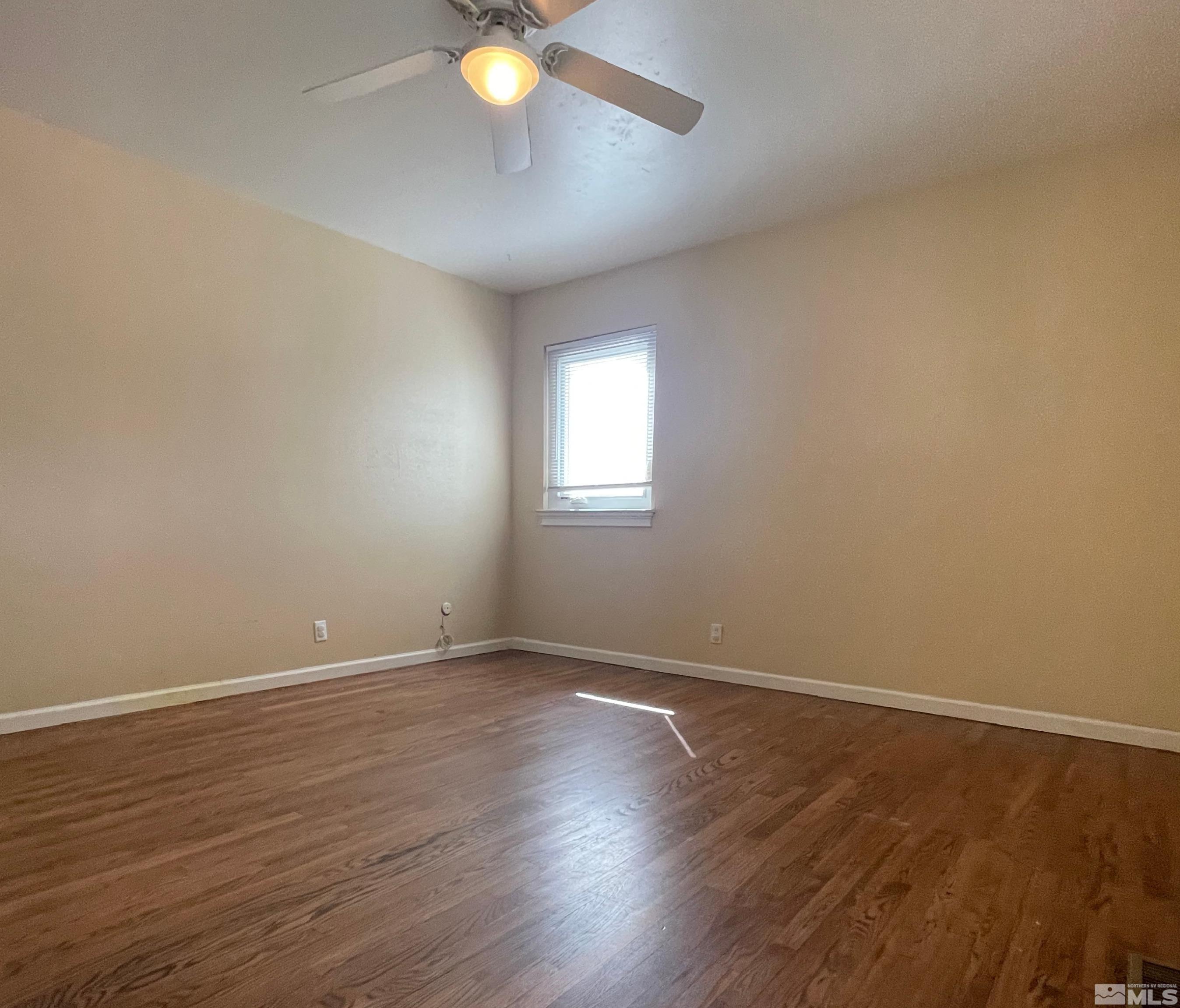 4500 Aster Drive Reno, NV 89502 - Photo 8 of 10 an empty room with wooden floor and windows