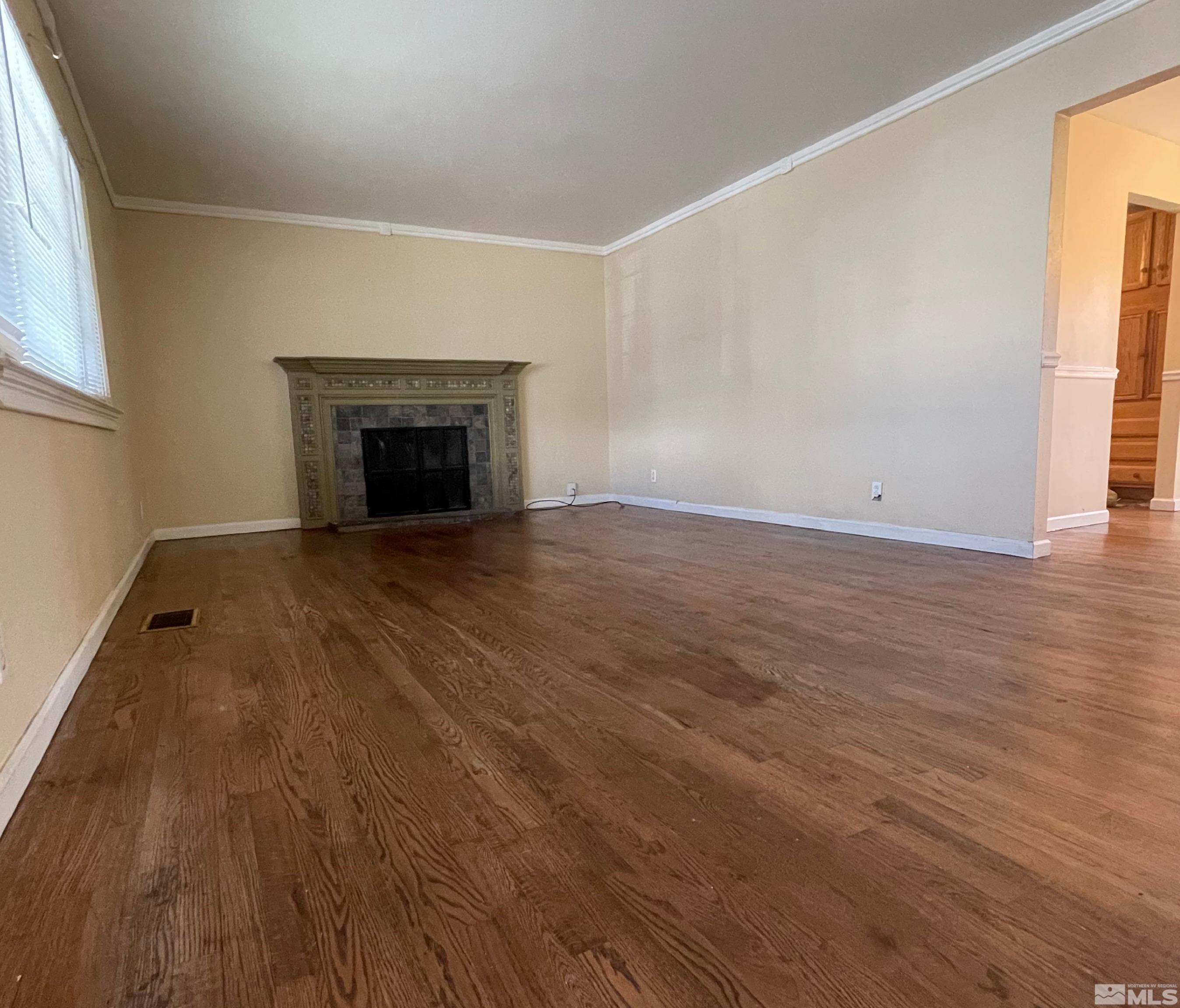 4500 Aster Drive Reno, NV 89502 - Photo 9 of 10 wooden floor fireplace and windows in an empty room