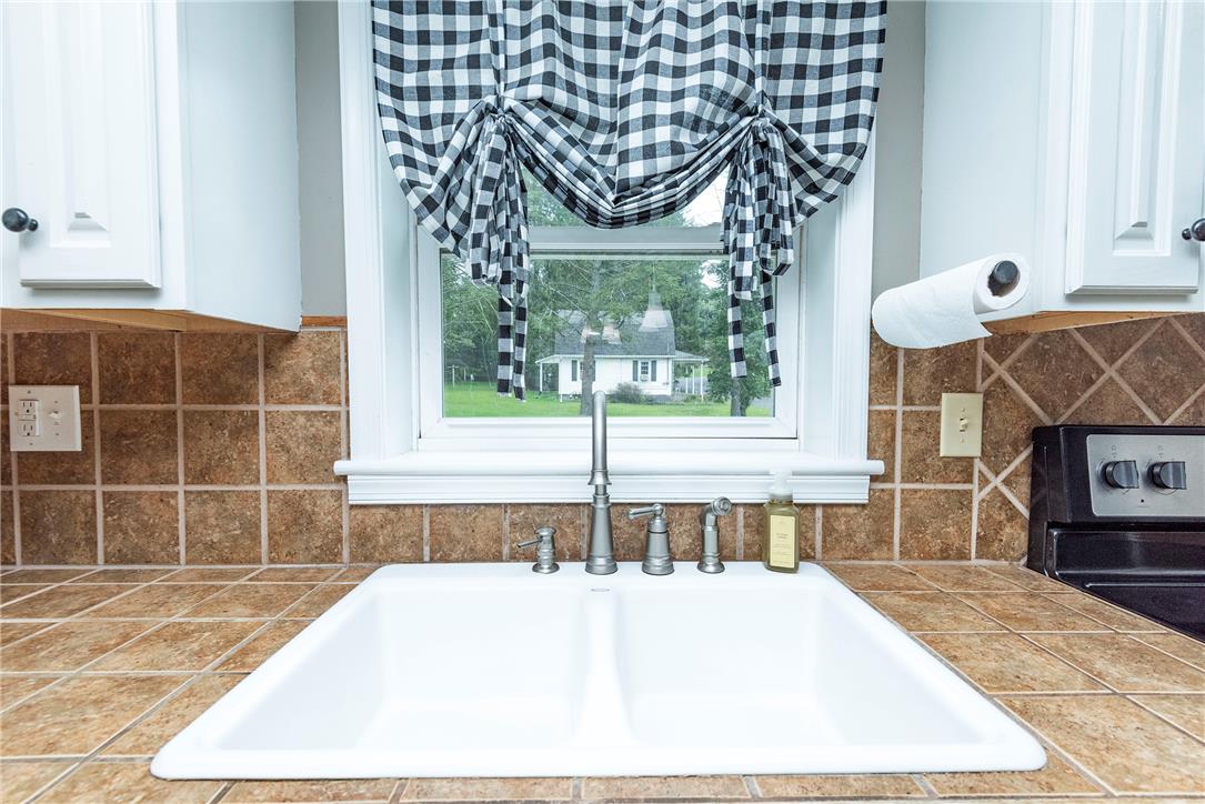 280 Oak Road Bangor, PA 18013 - Photo 13 of 52 A classic double sink rests below a window overlooking the peaceful backyard greenery.