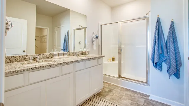 a bathroom with a double vanity sink and a mirror