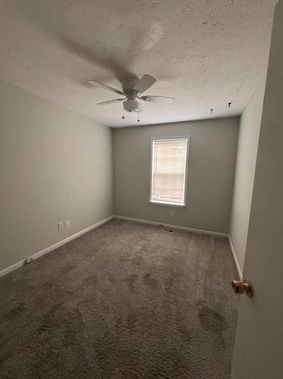 2174 Scarbrough Road Stone Mountain, GA 30088 - Photo 8 of 8 an empty room with windows and ceiling fan view