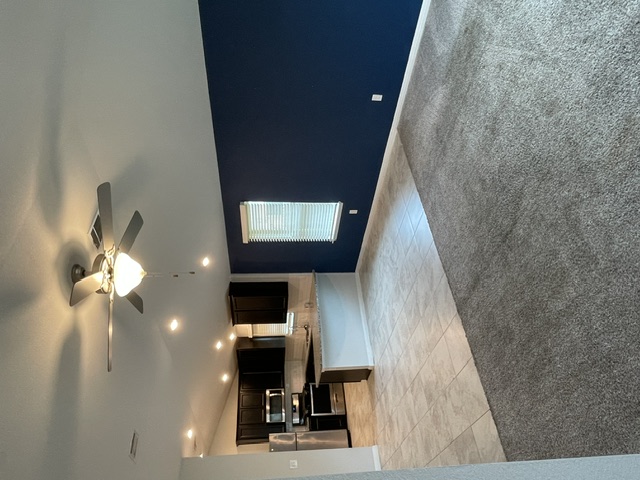 12401 Amber Lynn Path Manor, TX 78653 - Photo 9 of 33 Lofty ceilings with a ceiling fan and a view down to the main living area.