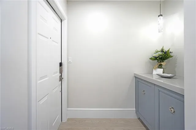 a bathroom with a white shower curtain and a potted plant