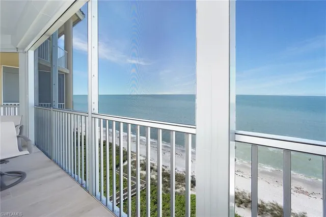 a view of a balcony with chair and wooden floor