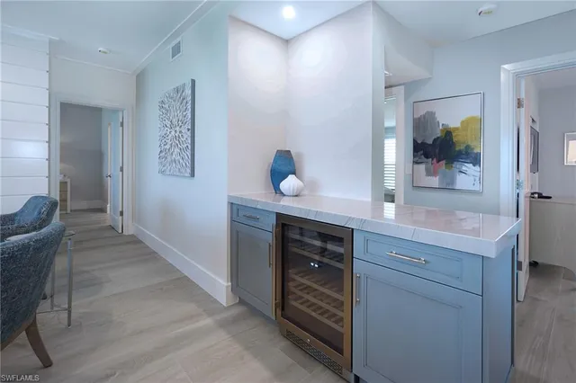 a living room with furniture a dining table and chairs with wooden floor