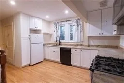 a kitchen with kitchen island granite countertop a sink stove and refrigerator