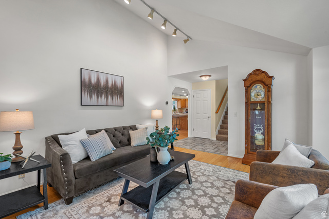1726 Wasatch Boulevard Sandy, UT 84092 - Photo 3 of 38 Vaulted ceiling living area featuring track lighting, wood-finish flooring