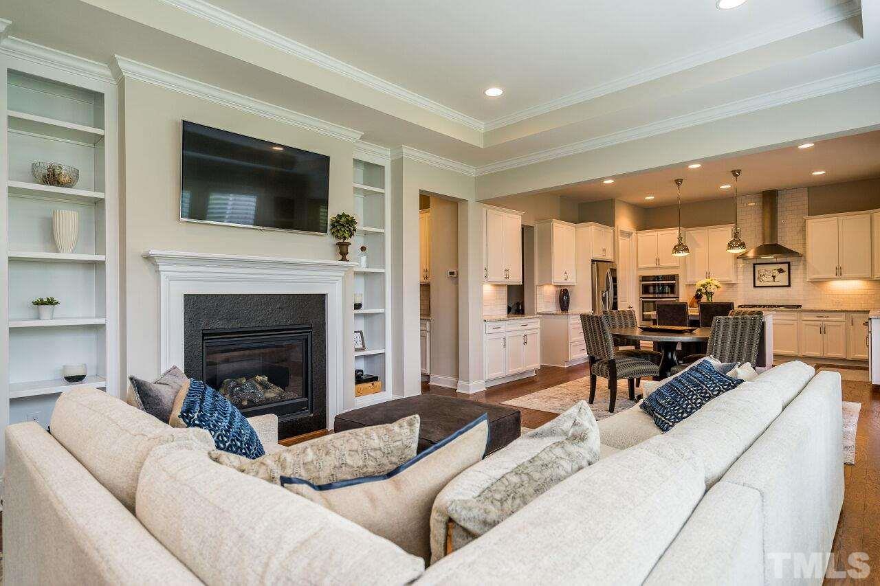 5268 Aleppo Lane Raleigh, NC 27613 - Photo 11 of 30 Easy flow in this living room with cozy fires and built in custom bookshelves.