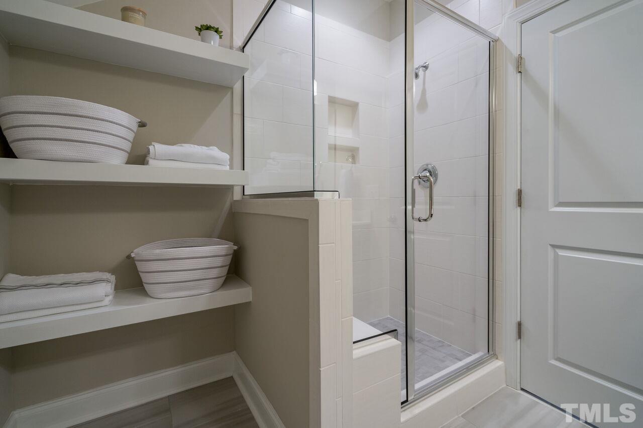 5268 Aleppo Lane Raleigh, NC 27613 - Photo 27 of 30 Full bathroom in the third level featuring glass enclosed walk-in shower and built in custom shelving!