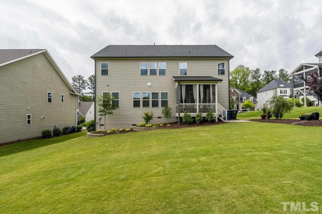 5268 Aleppo Lane Raleigh, NC 27613 - Photo 30 of 30 View of the green grass, tiered garden beds and flowers in bloom!