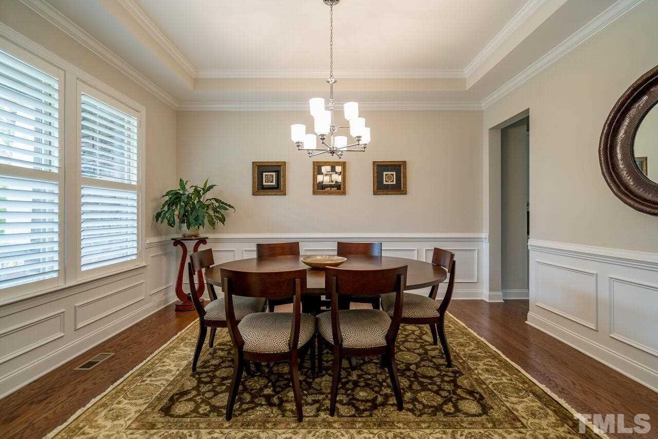 5268 Aleppo Lane Raleigh, NC 27613 - Photo 4 of 30 Chic dining room features tray ceiling, wainscoting, tray ceiling and butler's pantry!