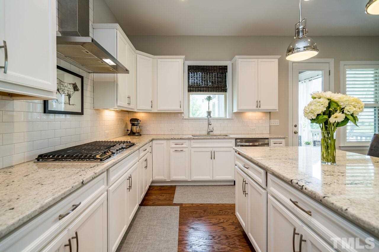 5268 Aleppo Lane Raleigh, NC 27613 - Photo 7 of 30 Enjoy the easy to use gas range with modern hood vent above. Tons of cabinet space w/ pull out drawers added for convenience.