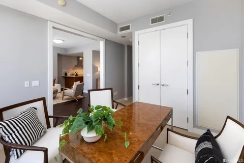 a workspace room with furniture and a potted plant