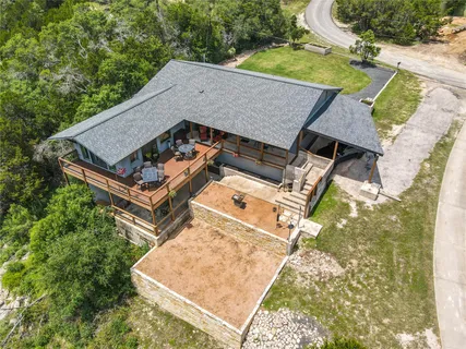 an aerial view of a house with swimming pool and patio