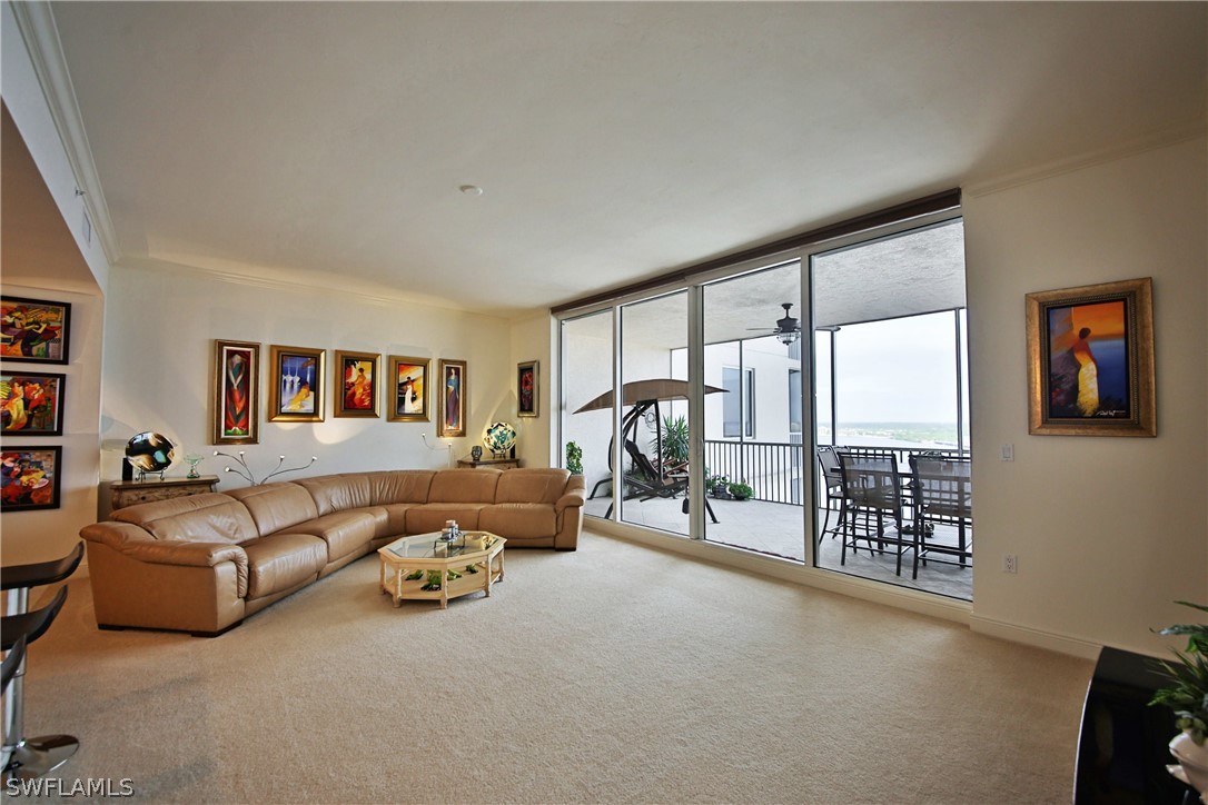 2090 West First Street, Unit 2107 Fort Myers, FL 33901 - Photo 11 of 35 a living room with furniture and a floor to ceiling window