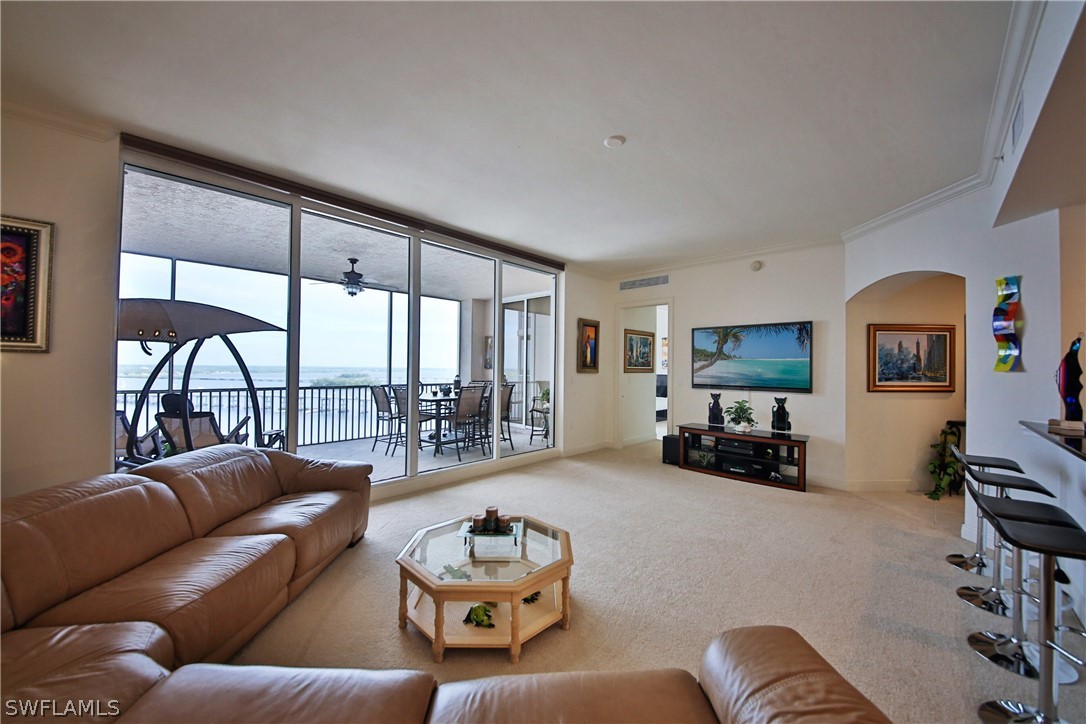 2090 West First Street, Unit 2107 Fort Myers, FL 33901 - Photo 13 of 35 a living room with furniture or couch and a flat screen tv
