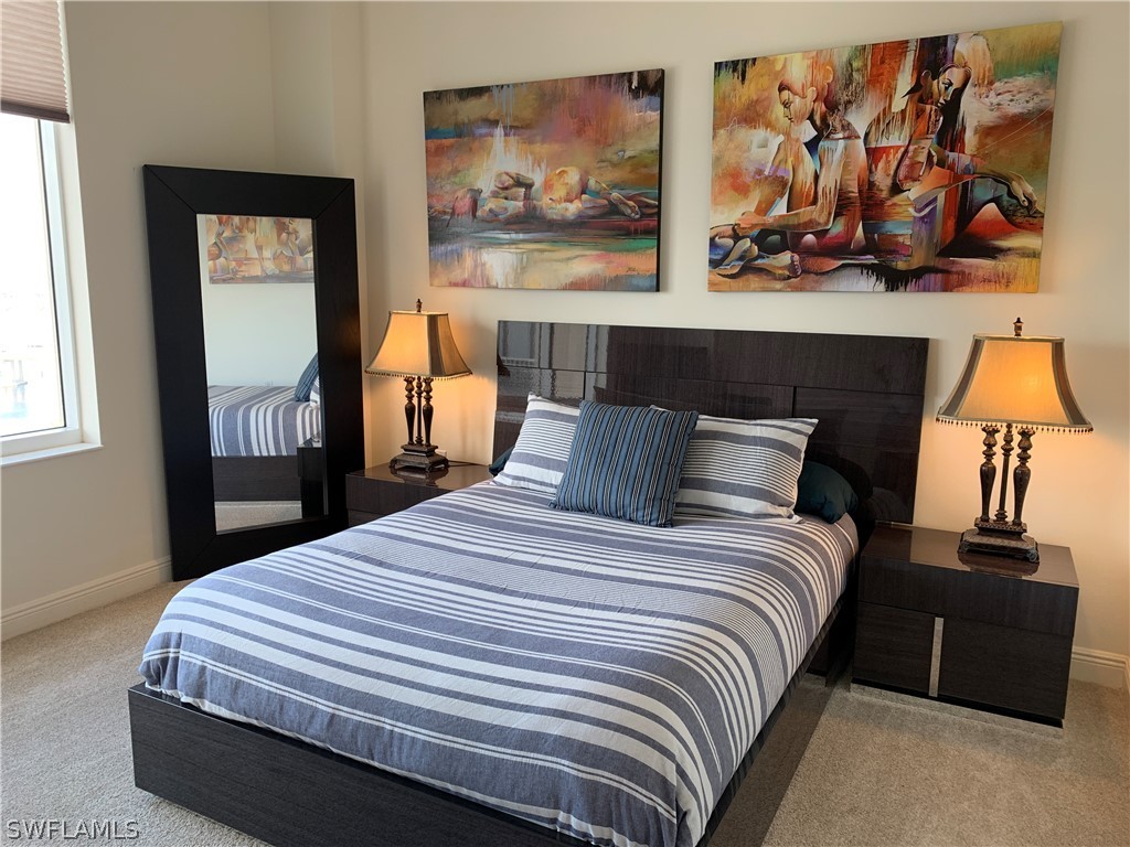 2090 West First Street, Unit 2107 Fort Myers, FL 33901 - Photo 16 of 35 a bedroom with a bed and wall painting