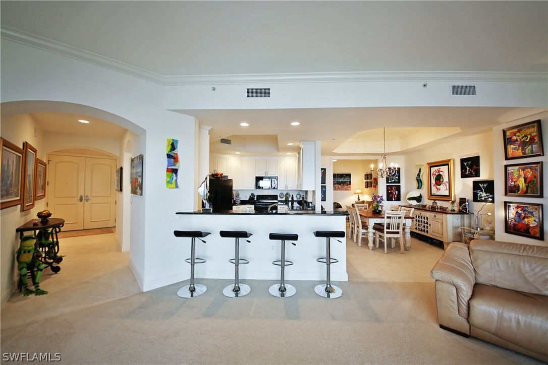 2090 West First Street, Unit 2107 Fort Myers, FL 33901 - Photo 20 of 35 a living room with lots of furniture and a large mirror