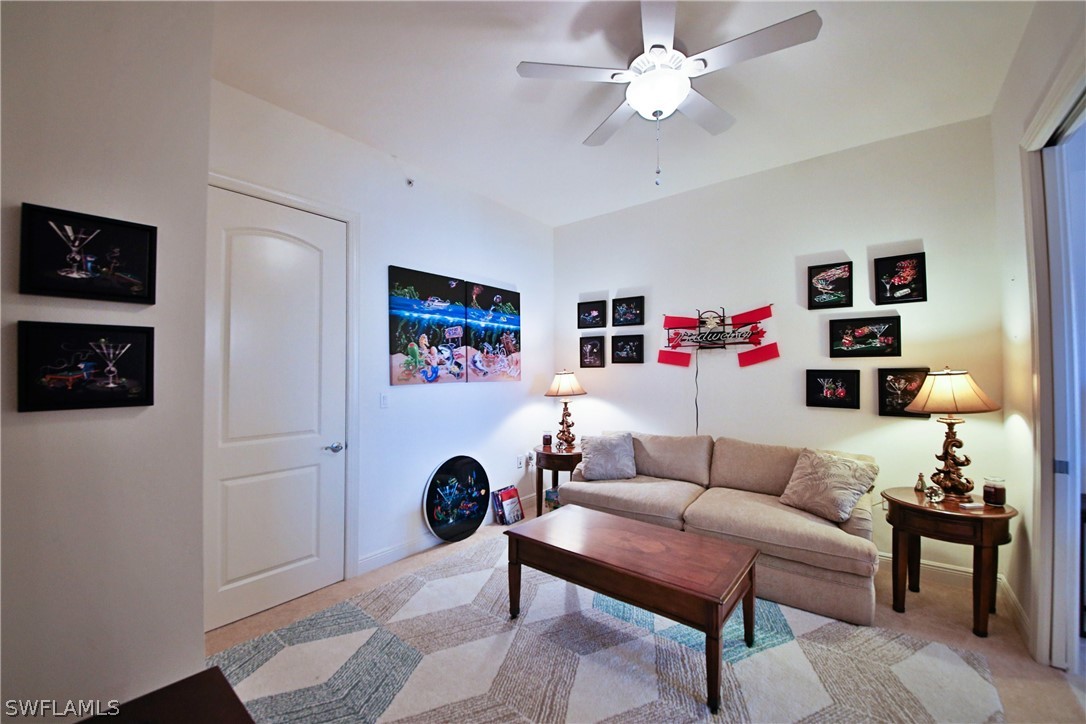 2090 West First Street, Unit 2107 Fort Myers, FL 33901 - Photo 23 of 35 a living room with furniture and a lamp