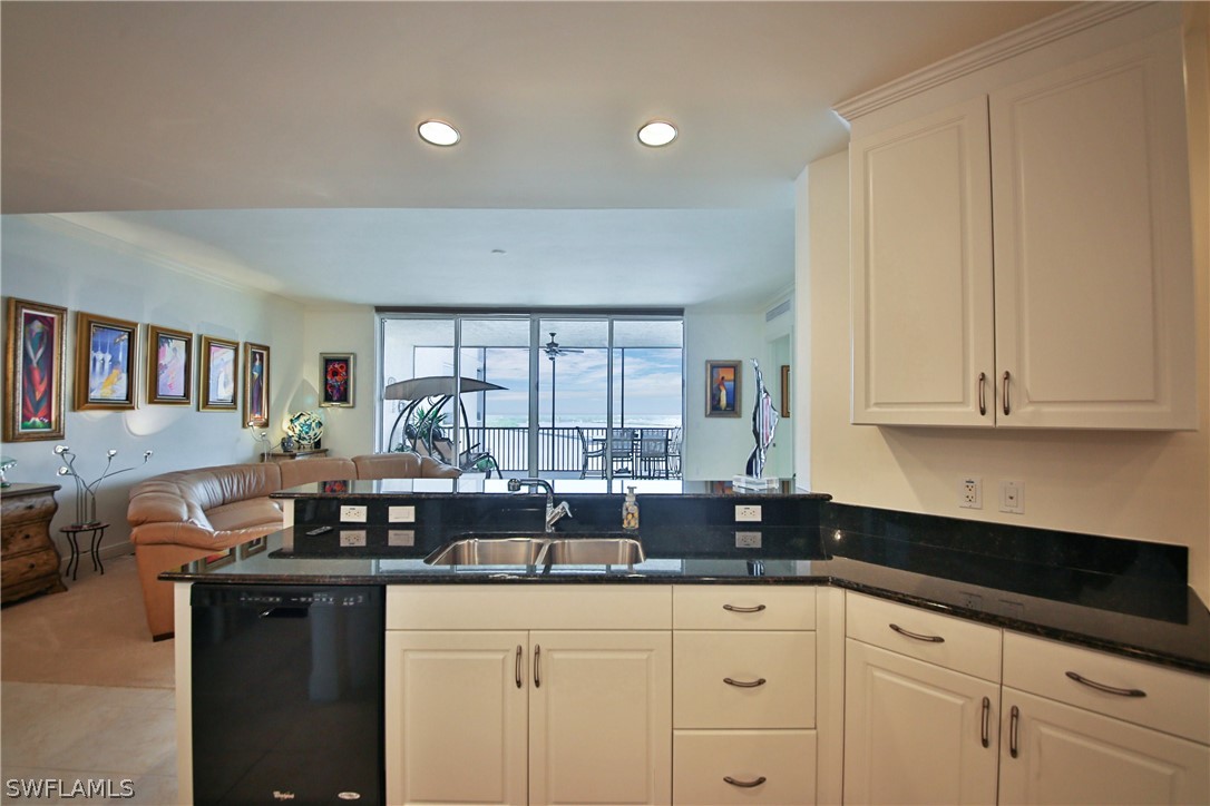 2090 West First Street, Unit 2107 Fort Myers, FL 33901 - Photo 24 of 35 a kitchen with granite countertop a sink a stove and cabinets