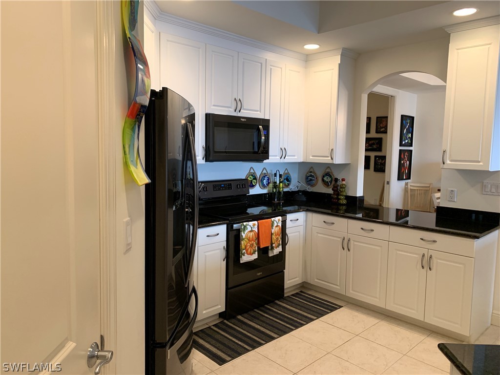 2090 West First Street, Unit 2107 Fort Myers, FL 33901 - Photo 28 of 35 a kitchen with stainless steel appliances a refrigerator and a stove top oven