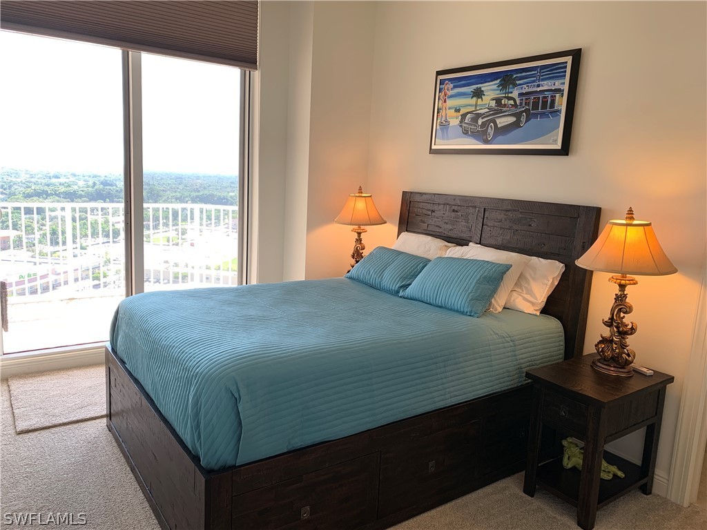 2090 West First Street, Unit 2107 Fort Myers, FL 33901 - Photo 3 of 35 a bedroom with a bed and a window