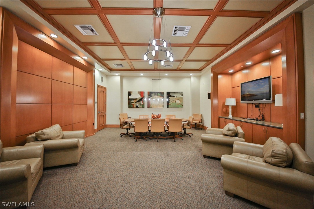 2090 West First Street, Unit 2107 Fort Myers, FL 33901 - Photo 34 of 35 a living room with furniture and a flat screen tv
