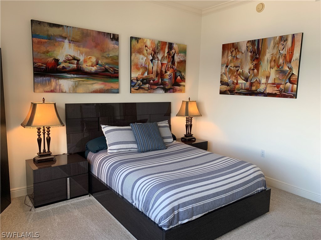 2090 West First Street, Unit 2107 Fort Myers, FL 33901 - Photo 9 of 35 a bedroom with a bed and painting on the wall