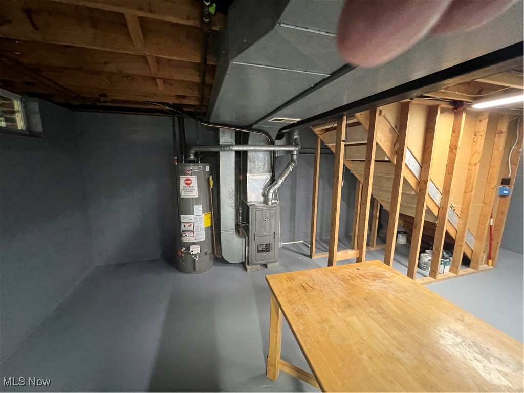 1279 Lander Road Cleveland, OH 44124 - Photo 33 of 37 Unfinished below grade area with stairs, water heater, and heating unit