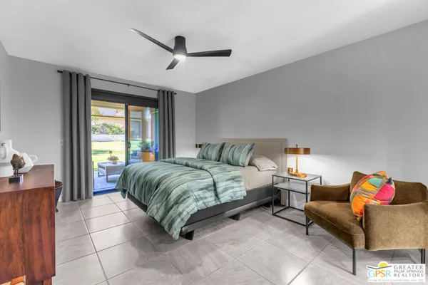 a spacious bedroom with a bed and a couch