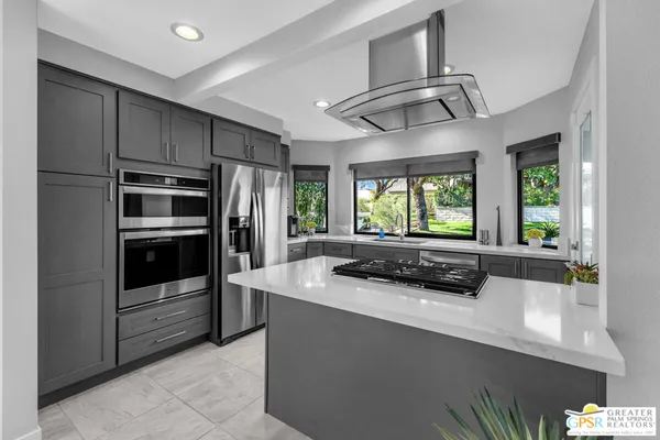 a kitchen with stainless steel appliances a stove and a refrigerator