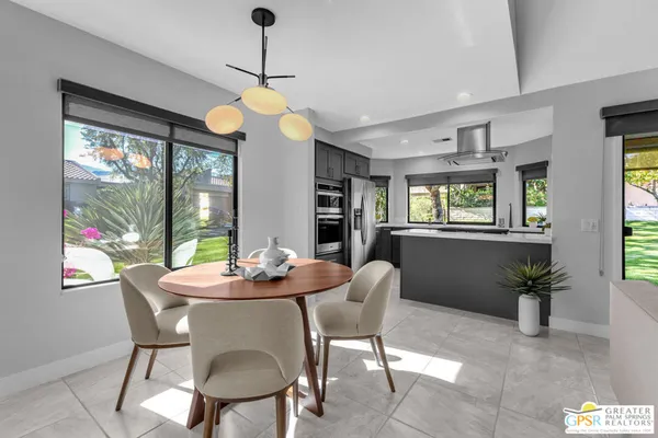 a dining room with furniture window and wooden floor
