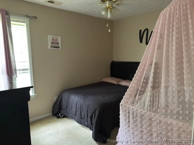 a view of a couches in the patio with a small yard