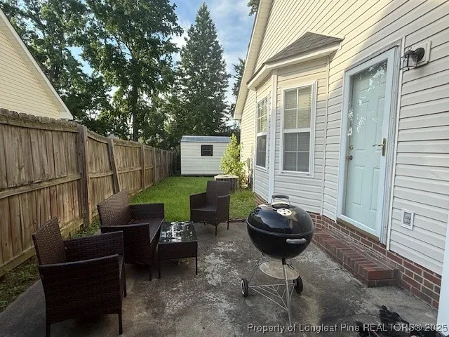 a backyard of a house with table and chairs