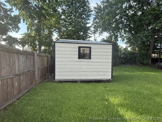 a view of a backyard with large trees