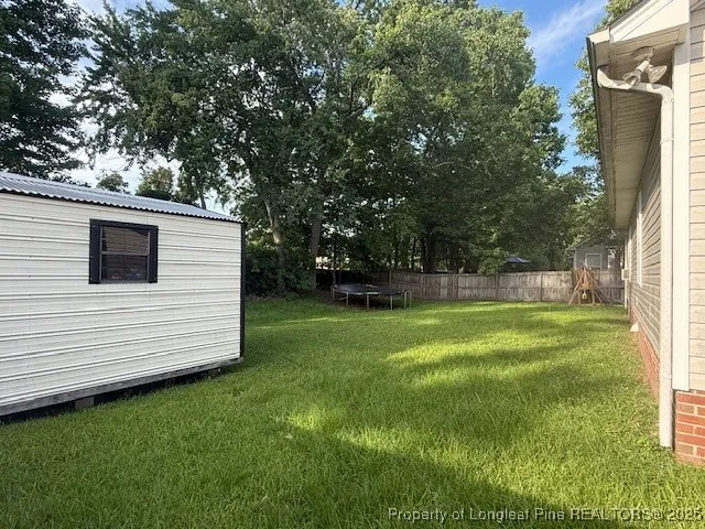a view of a white house with a backyard