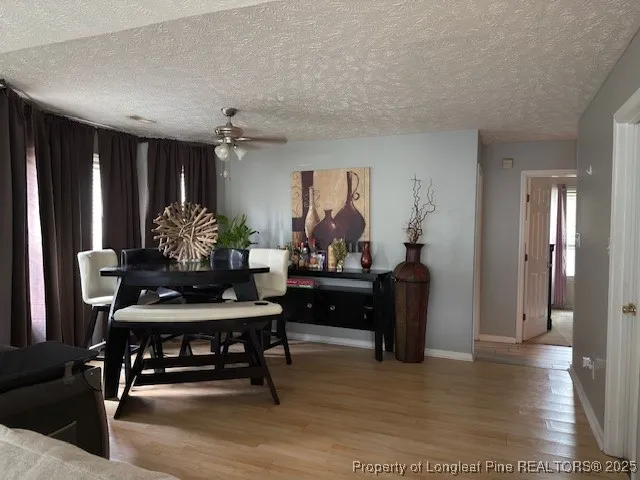 a kitchen with stainless steel appliances a stove a sink a refrigerator a microwave a sink and cabinets