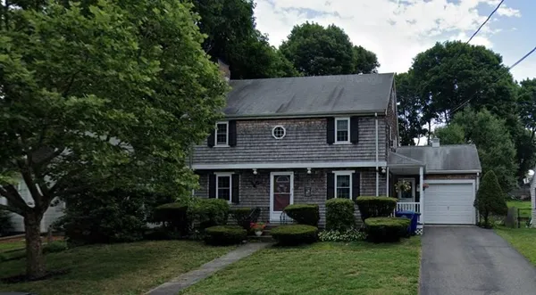 a front view of a house with a yard table and chairs
