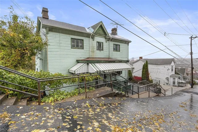 a view of a chair and table in the backyard