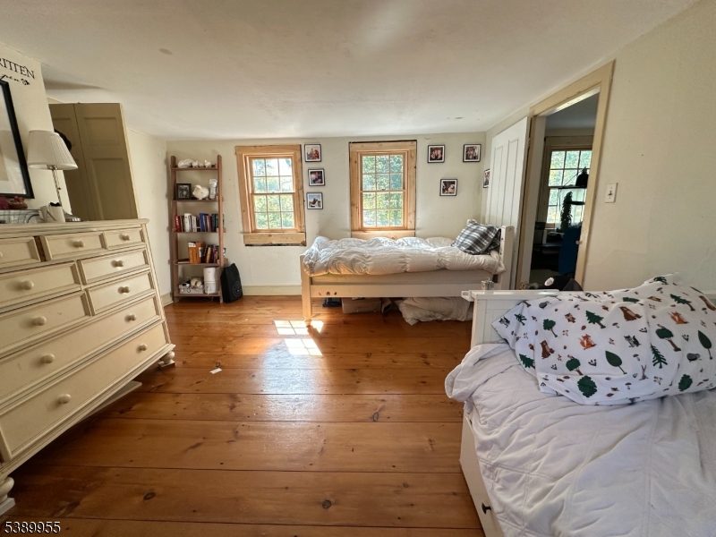 223 Federal Twist Road Stockton, NJ 08559 - Photo 21 of 28 a spacious bedroom with a bed and wooden floor