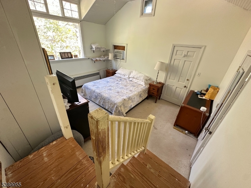223 Federal Twist Road Stockton, NJ 08559 - Photo 22 of 28 a bedroom with a bed and a dresser next to a window