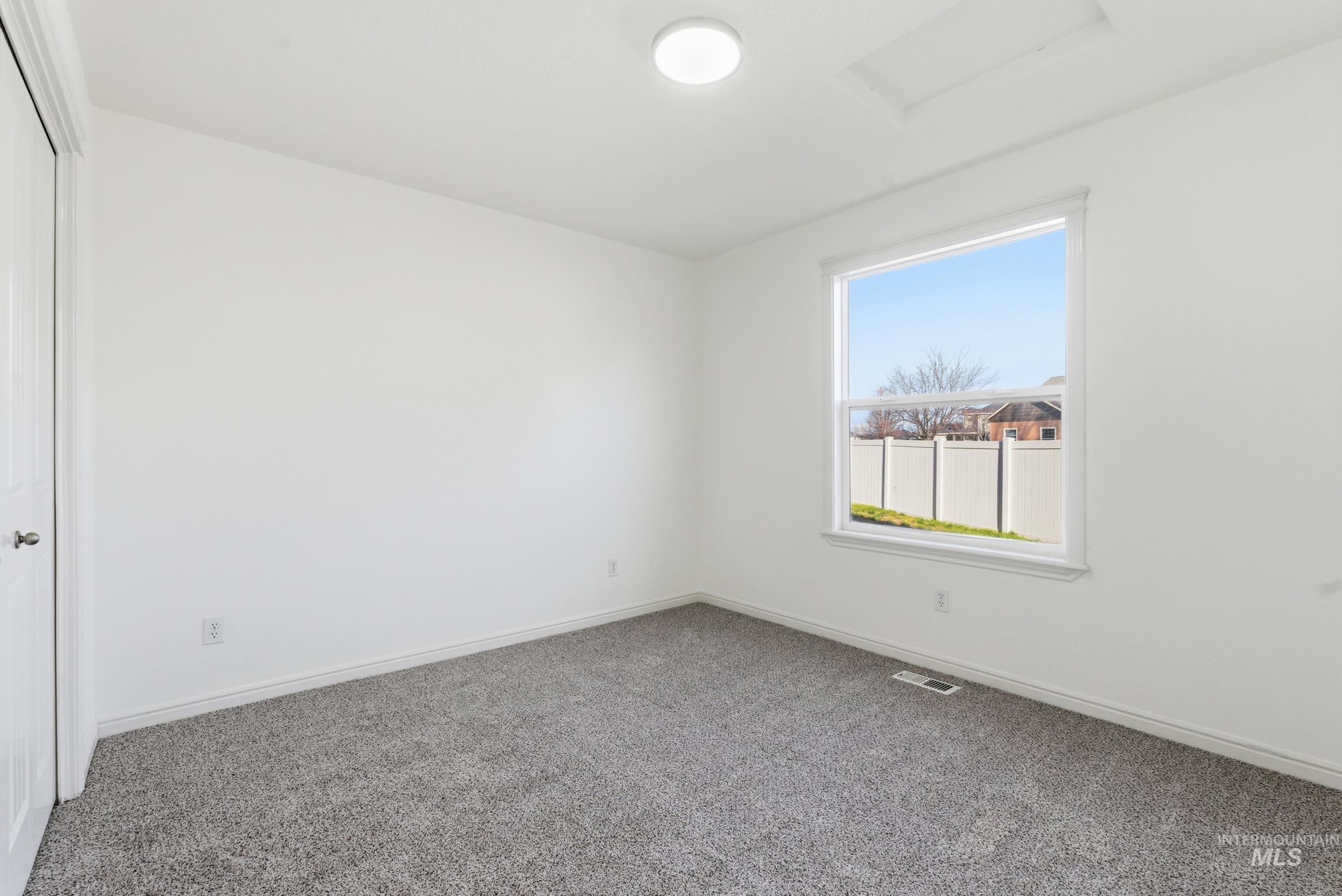 1133 North Powder River Drive Middleton, ID 83644 - Photo 21 of 33 Unfurnished bedroom featuring carpet floors, a closet, and attic access