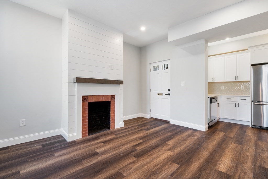 31 Monadnock Street, Unit 2 Boston, MA 02125 - Photo 1 of 11 a view of a kitchen with a sink and a fireplace