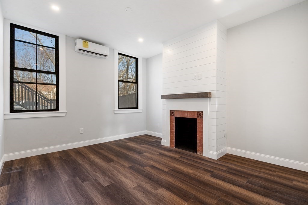31 Monadnock Street, Unit 2 Boston, MA 02125 - Photo 2 of 11 a view of an empty room with wooden floor and a window